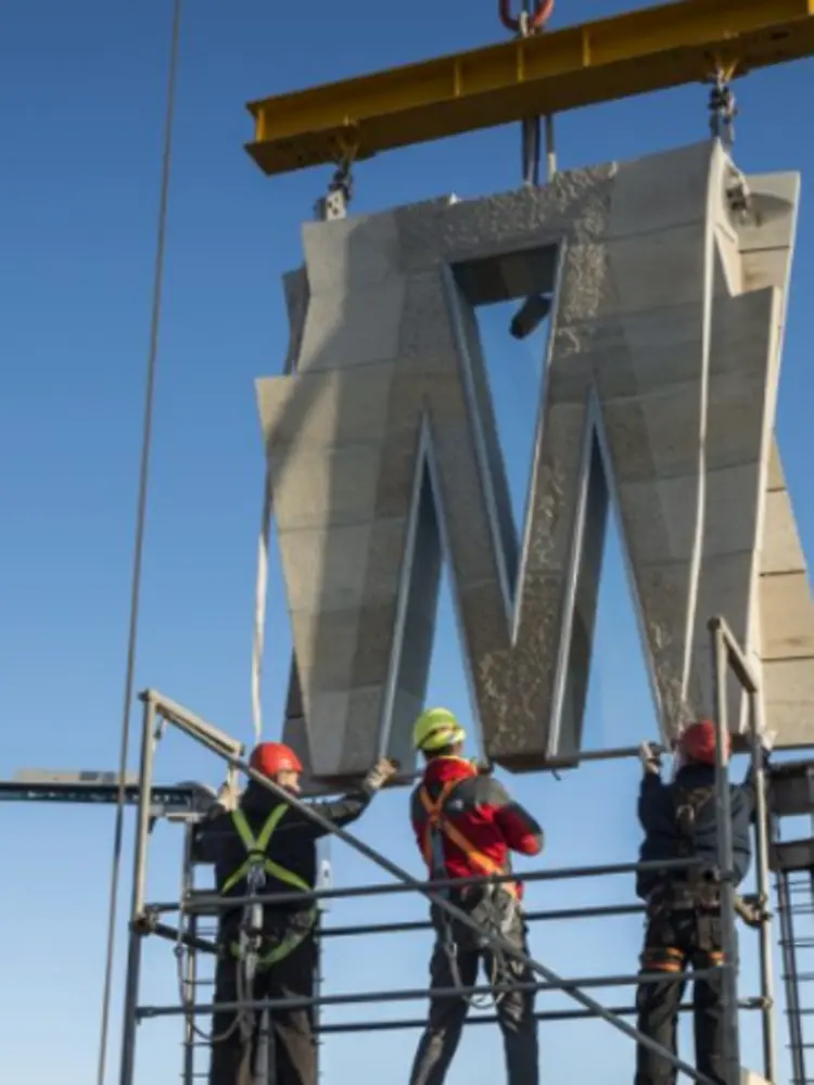 Assembly of prefabricated structural panels at height during tower construction