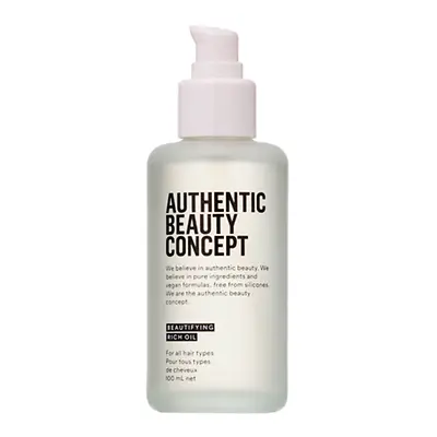 Botella del Aceite Embellecedor Intensivo de Authentic Beauty Concept con dispensador, envase translúcido con etiqueta negra sobre fondo blanco neutro.